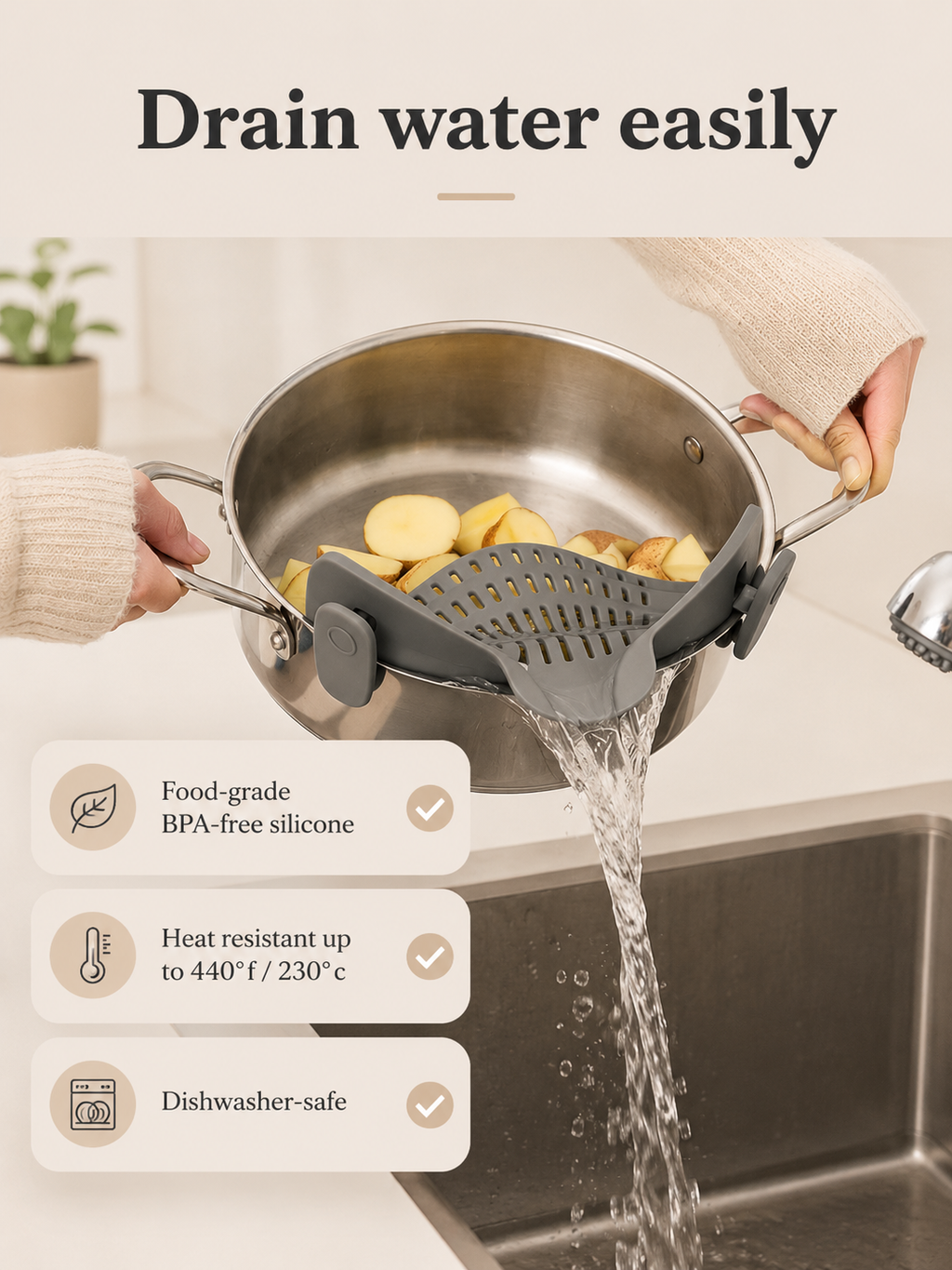 Grey quick-drain pasta strainer with perforated silicone insert, draining water from a pot