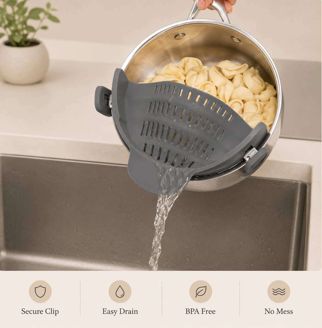 Grey quick-drain pasta strainer with silicone insert, clipped on a pot while water drains