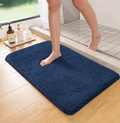 Deep blue plush bathroom mat with soft shag texture and rounded edges