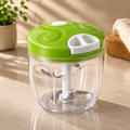 Manual multipurpose mixer with green lid, white crank handle, and clear mixing bowl