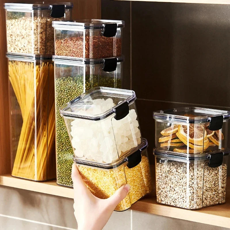 Kitchen storage jar set: clear canisters with black latch lids, filled with rice, beans, and pasta