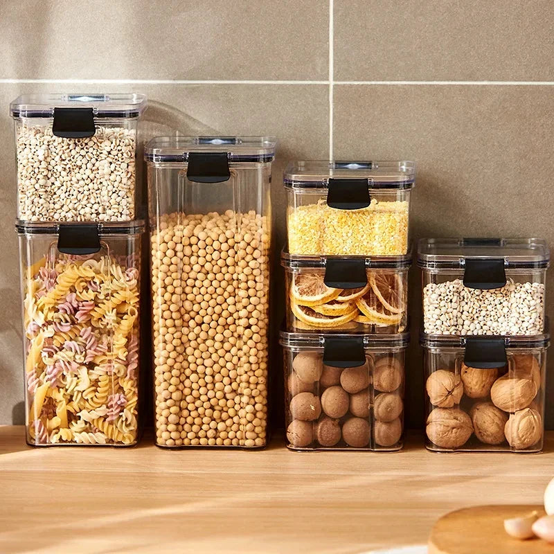 Kitchen storage jar set: clear canisters with black latch lids, filled with dry pantry items